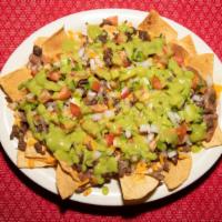 Nachos Supreme · Crispy tortilla chips topped with beans, cheese, choice of meat, pico de gallo and guacamole