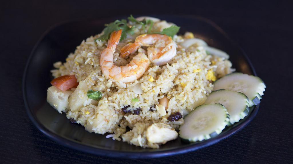 Pineapple Fried Rice · Fried rice with shrimp & chicken, egg, pineapple, tomatoes, raisin, cashew nuts in curry powder.