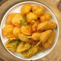 Veggie Pakora Picker · (Eight pieces) Assorted vegetables dipped in a light batter and fried until golden brown.
