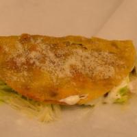 Crispy Taco · Grilled crispy corn tortilla, meat, melted cheese, lettuce, sour cream, guacamole, and Parme...
