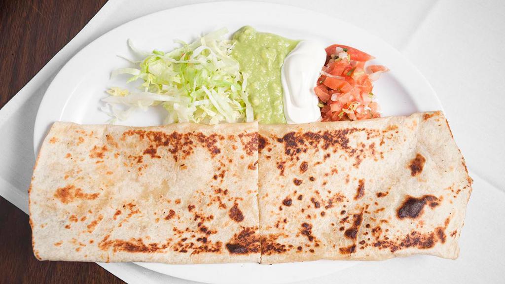 Super Quesadilla · Flour tortilla with meat and cheese inside. A side of lettucce, sour cream, guacamole, and pico salsa.