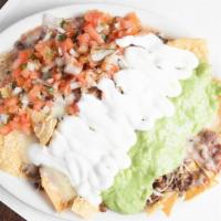 Super Nachos · Meat, chips, beans, cheese, sour cream, guacamole, and pico salsa.