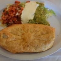 Chimichanga · Deep fried flour tortilla with meat, rice, refried beans, and cheese inside. Side of lettuce...