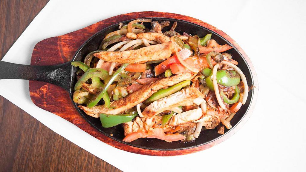 Fajitas  De Pollo · Chicken  strips cooked with bell peppers, tomatoes, and onions.