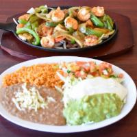 Fajitas De Camaron · One dozen Shrimp with tomatoes, onions and bell peppers, rice, refried beans, lettuce, sour ...