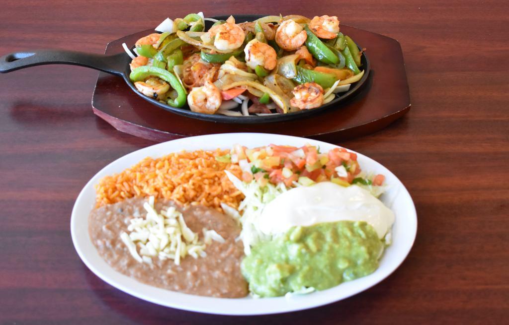 Fajitas De Camaron · One dozen Shrimp with tomatoes, onions and bell peppers, rice, refried beans, lettuce, sour cream, guacamole, pico salsa, and tortillas.
