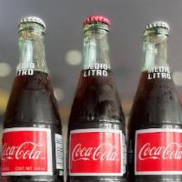 Coca Cola 355 Ml · Glass bottled soda.