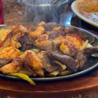 Mixed Fajitas · Chicken and beef. Tender pieces of chicken and beef grilled to perfection with bell peppers,...