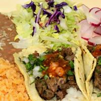 Soft Tacos · Two soft tacos topped with onion, cilantro and salsa served with rice and beans.