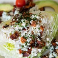 Wedge · Iceberg, bacon, avocado, cherry tomatoes, chives, blue cheese crumbles, blue cheese dressing.