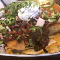“Haunted” Nachos · Thick tortilla chips covered with cantina beans, melted cheddar, and ghost pepper cheese, fr...