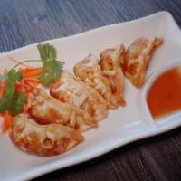 Gyoza (Potstickers) · With pork and veggies. Serve with sweet and sour sauce.