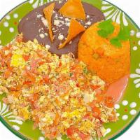 Huevos A La Mexicana · Scrambled eggs with chopped tomato, onion, and jalapeño served with black beans and rice.