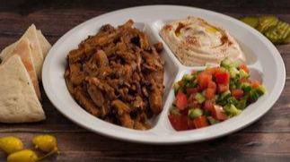 Veggie Shawarma Plate · Soy-Meat cut into bite-size pieces grilled with onion, mushroom, and spices, served with hum...