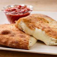 Deluxe Calzone · Pepperoni, sausage, mushroom, onion, green pepper and black olive. Served with marinara sauce.