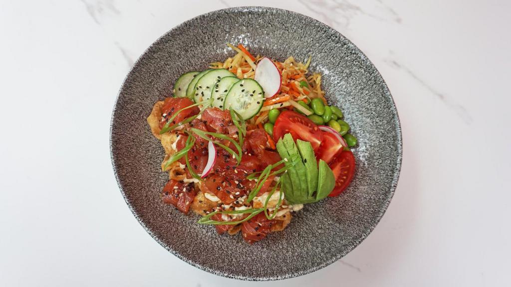 Tuna Poke Bowl · Sashimi grade ahi tuna poke, crispy wontons, green papaya slaw, miso dressing, brown rice.