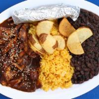 Mole Poblano · Shredded chicken smothered in delicious mole, served with spanish rice, black beans, and cub...