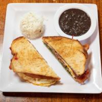 Bodega Sandwich · Eggs, bacon, Swiss, tomato, spinach, sweet onions, Dijon, w/beans & rice. (Add Ham or Avo op...