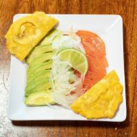 Avo Cubano Side · Sliced avo, tomato & sweet onions, drizzled w/ lime & EV olive oil, served with Tostones/pl...