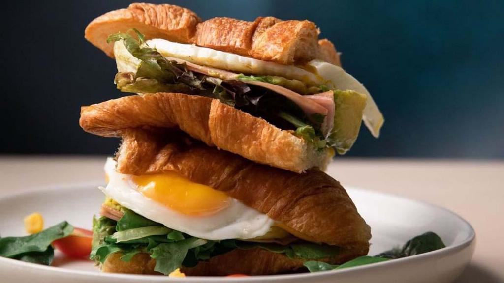 Croissant Avocado And Ham Sandwich · Avocado, ham, cheese, mayo, butter, sunny side up egg, toasted croissant
.