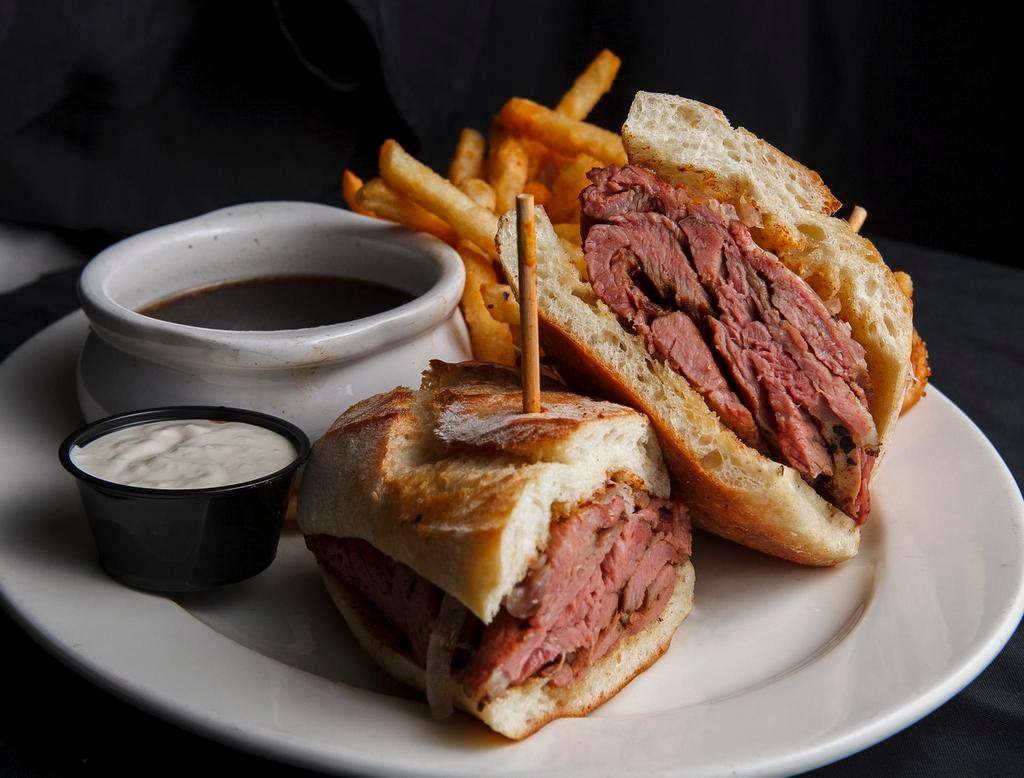 Tri Tip Dip · Slow roasted tri tip, grilled onions, horseradish sauce, toasted French roll, au jus.