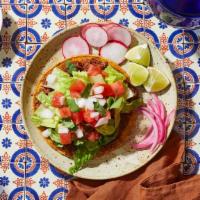 Tostada · crisp flat tortilla, birria, lettuce, chopped tomatoes, chopped onion, cilantro