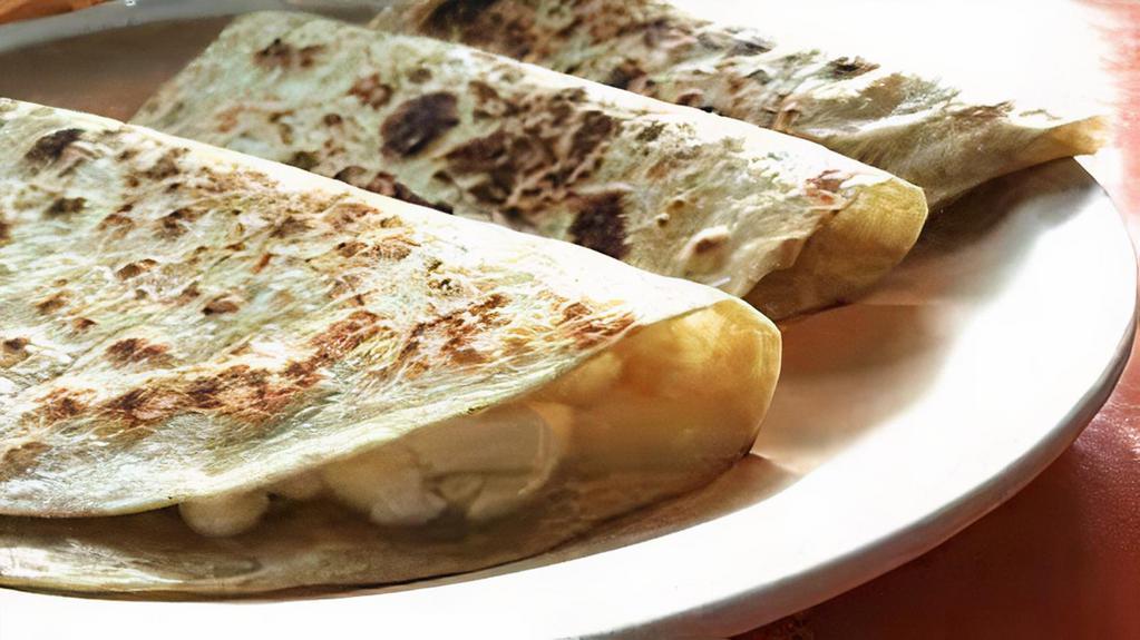 Quesadillas · steak, onions, cilantro, mild, hot sauce, topped with cheese.