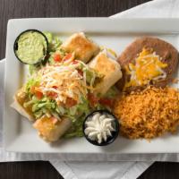 Tio Leo'S Flautas · Two grilled flour, beef, chicken & cheese, tomatillo sauce, lettuce, tomato, jack, cheddar, ...