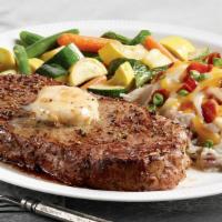 New York Strip Steak · Seasoned and seared 10 oz. steak topped with house-made roasted garlic butter. Served with l...