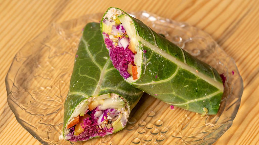 Farmer'S Market Wrap · Collard green leaf smothered in hummus or nut and seed cheese, filled with cucumbers, tomatoes, red bell peppers, red cabbage, sprouts, and topped with ranch dressing.