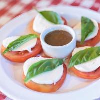 Caprese Salad · Fresh sliced mozzarella, tomatoes and basil served with balsamic vinaigrette.