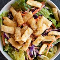 Asian Crispy Wonton Salad (12 Oz) · Romain lettuce, purple cabbage, and carrots in a creamy sesame dressing, topped with crispy ...