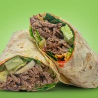 Beef Shawarma Wrap · Served with 14” flour Tortilla, hot sauce, garlic sauce, lettuce, and onion.
Beef wrap will ...