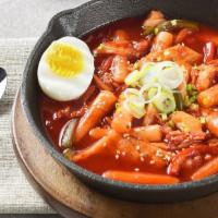 Dduk-Bokki  · Spicy with a hint of sweetness korean soup with Rice Cakes, Fish Cake, Cabbage, with half ha...