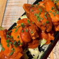 Buffalo Wings · Organic crispy fried chicken wings w/ buffalo sauce and choice of blue cheese or ranch.