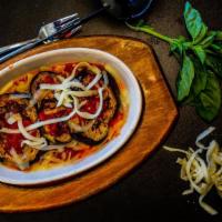 Eggplant Parmigiana · Oven-roasted fresh eggplant with marinara sauce. Covered with mozzarella cheese and fresh ba...