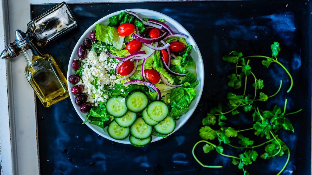Greek Salad · Romaine lettuce, red onion, tomato's, cucumber, Kalamata olives, and feta cheese, Italian dressing