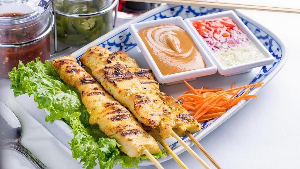 Chicken Satay (4) · Four skewers of grilled marinated chicken served with cucumber sauce and warm peanut sauce