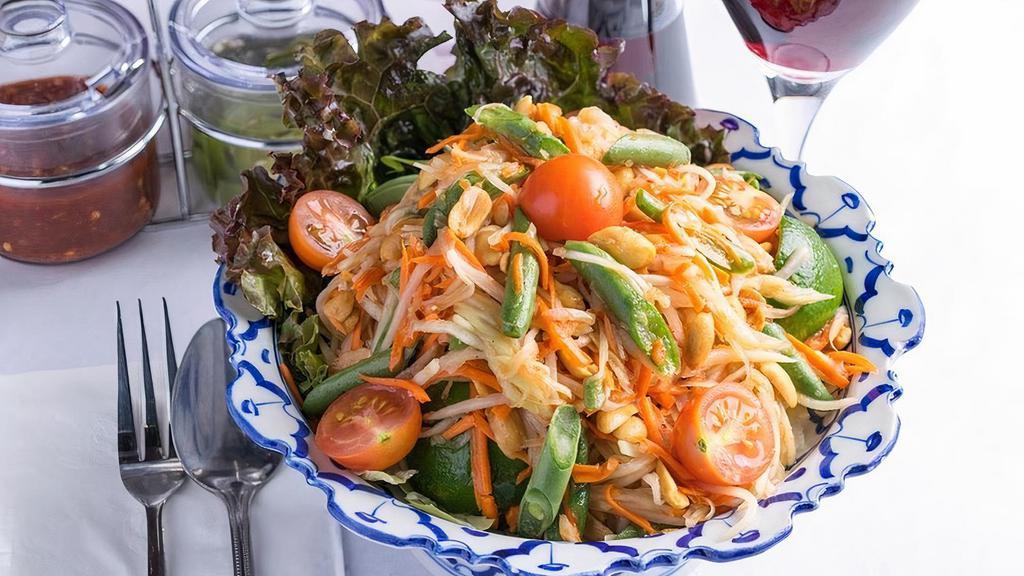 Papaya Salad · Shredded green papaya with green beans,. tomatoes, carrots, fish sauce and peanuts. tossed with a garlic lime dressing – 11.99. Add 2.00 more for shrimp.. Can be made vegan with no fish sauce.