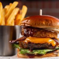 Smokehouse Burger · Sesame Brioche Bun – BBQ sauce – Double Melted Cheddar – Bacon – Onion Ring – Lettuce – Toma...