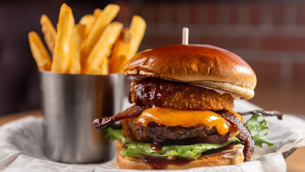Smokehouse Burger · Sesame Brioche Bun – BBQ sauce – Double Melted Cheddar – Bacon – Onion Ring – Lettuce – Tomato – Bread & Butter Pickles – Mayo