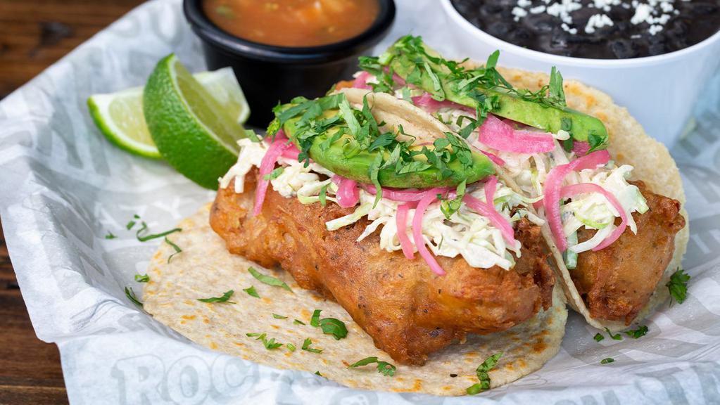 Baja Beer-Battered Fish Tacos · Chipotle Slaw – Avocado – Marinated Red Onions – Cilantro – Salsa – Served with Black Beans & Limes