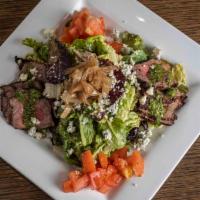 New York Steak Salad · Arugula, tomatoes, caramelized onions, serrano pesto, blue cheese, roasted honey garlic oreg...