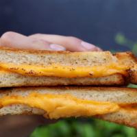 Classic Grilled Cheese · Melted American cheese grilled between two slices of buttered bread.