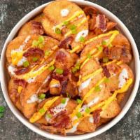 Loaded Potato Wedges · Baked potatoes topped with bacon, cheddar, smoked paprika, sour cream and scallions.