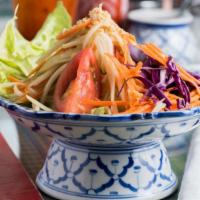Green Papaya Salad · Shredded green papaya tossed in a lime and tamarind sauce with tomatoes, ground peanut and g...