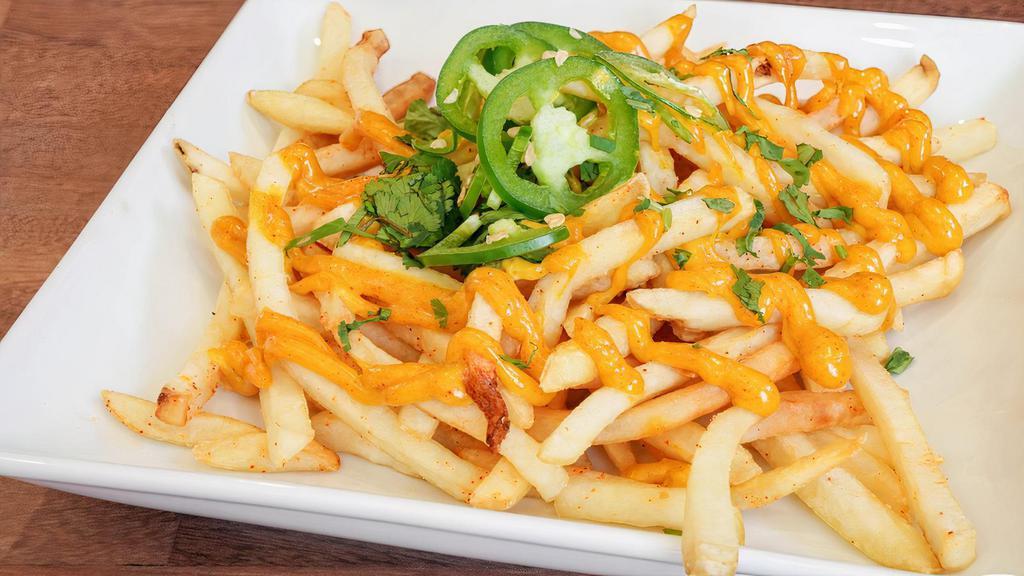 Curry Fries · Curry mayo drizzle, topped with jalapeno and cilantro.
