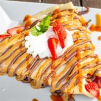 Crepetastic · Strawberries, bananas, & nutella topped with dulce de leche, house strawberry mango sauce, &...