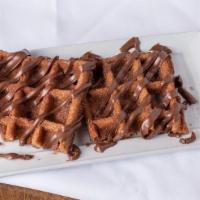 Churro Waffle · The happy marriage of churros and waffle, on a stick, and drizzled with hot chocolate.