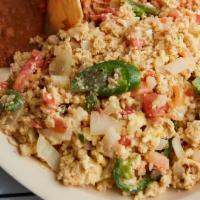 Huevos Mestizos · Scrambled eggs with sauteed onions, jalapeños, tomatoes. Served with rice, beans and tortill...
